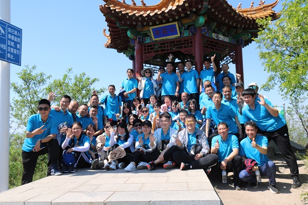 Group photo of Holy Shield partners at the top of the mountain